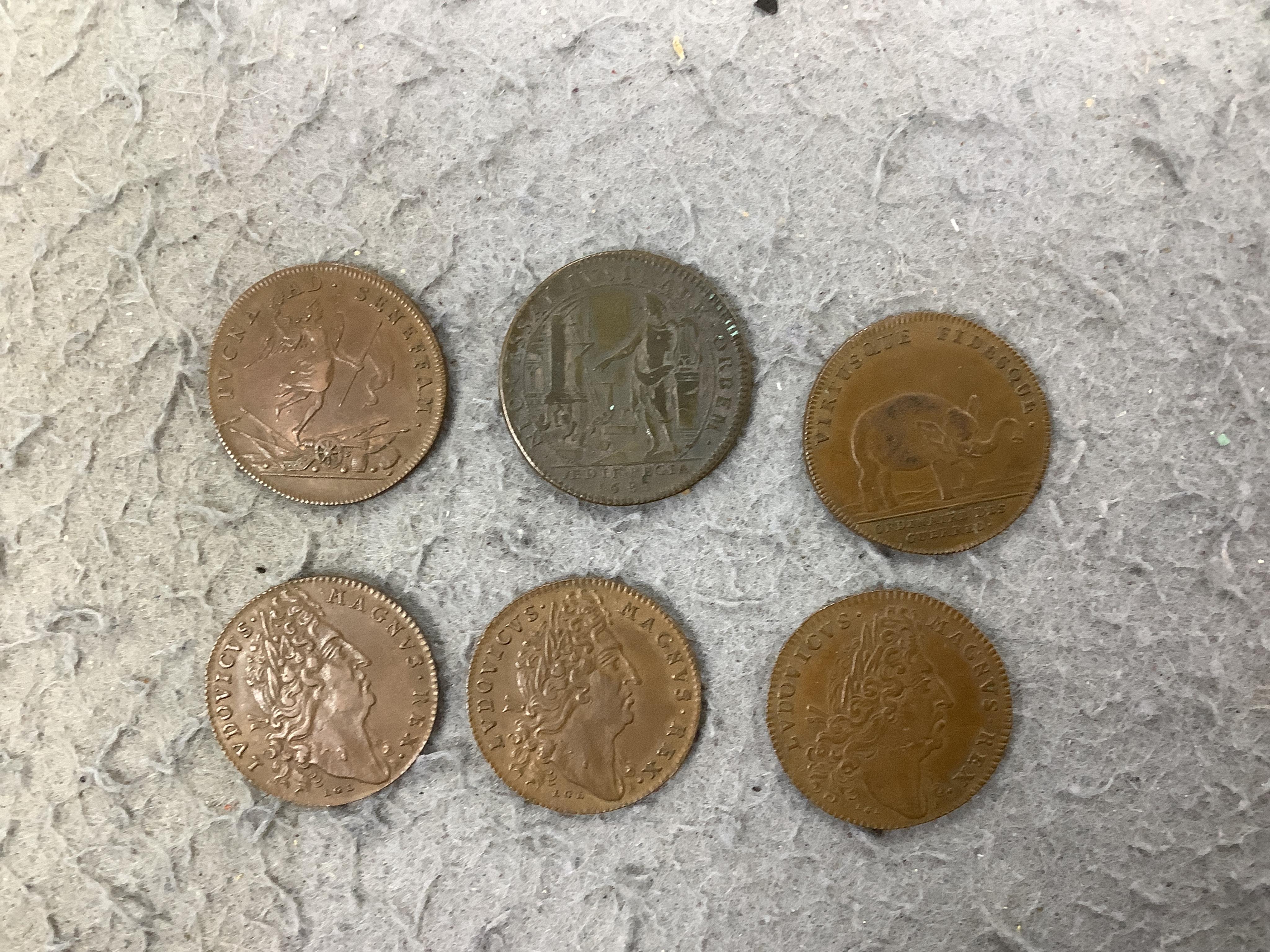 A large collection of halfpenny tokens and gaming tokens, 17th to early 20th century, in an album